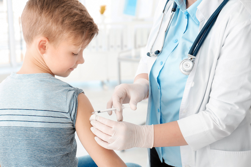 Doctor vaccinating little boy in hospital; Blog: Are Vaccines safe for children?