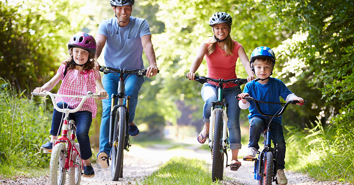 Family On Cycle Ride In Countryside; blog: 8 Ways to Encourage Your Child to Be Physically Active