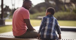 Father talking to son near pool side; blog: 8 Tips for Talking to Kids About Drugs