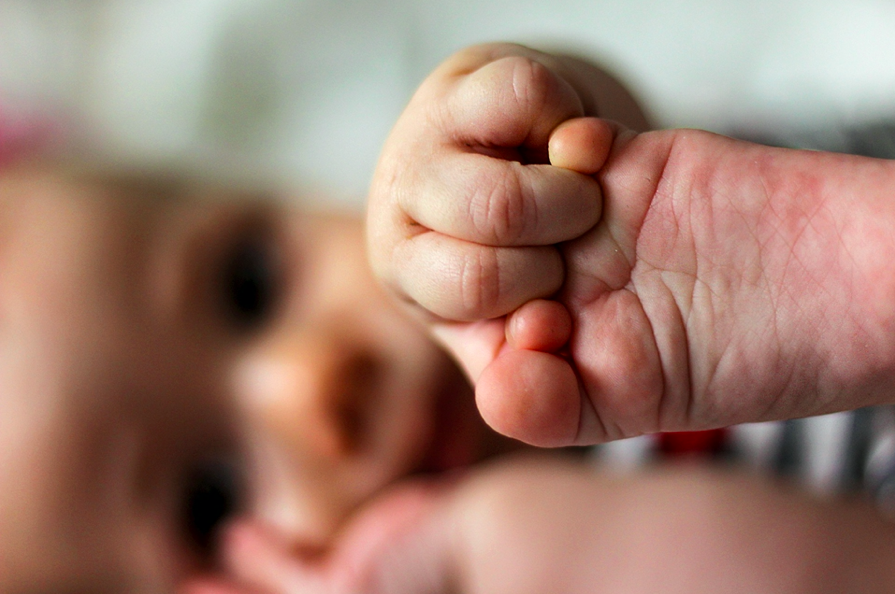 baby playing with feet NATIONAL PREMATURITY AWARENESS MONTH