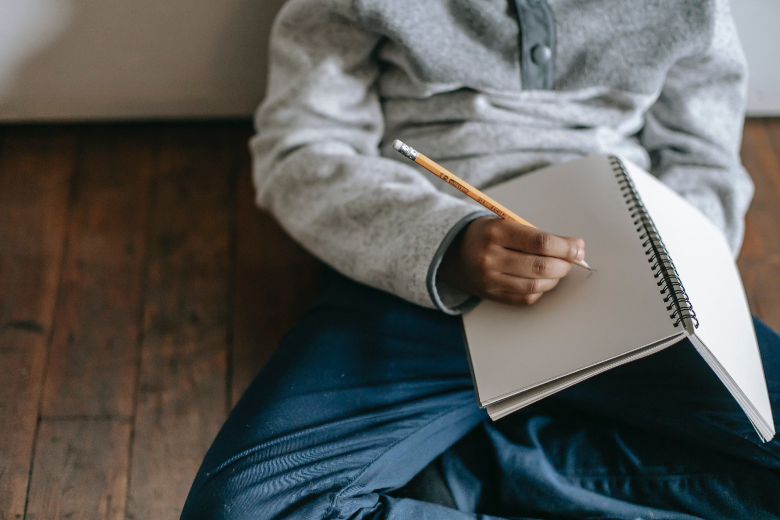 little boy writing in a journal