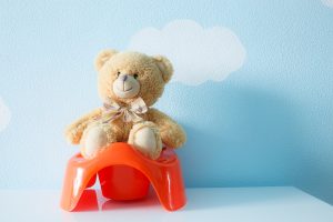 Cute toy sitting on the potty