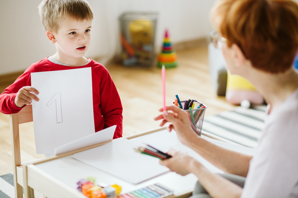 Boy in red sweater learning to count during extra-curricular activities / blog - ADHD and ADD in children